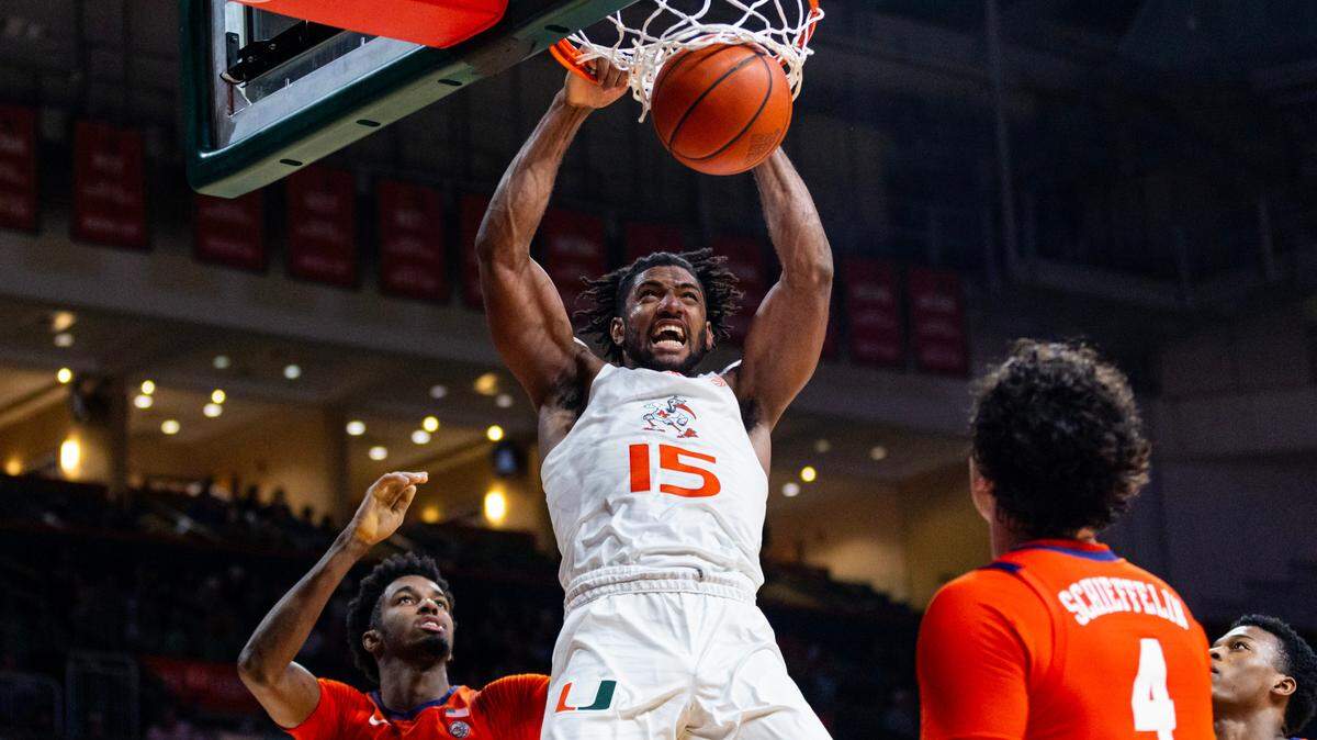 Miami Hurricanes forward Norchad Omier dunks over University of Clemson forward Chauncey Wiggins (21) as forward Ian Schieffelin (4) looks on during the second half of an NCAA basketball game at the Watsco Center in Coral Gables, Florida, on Wednesday, January 3, 2024. Omier missed the Syracuse game game Saturday with an ankle injury.