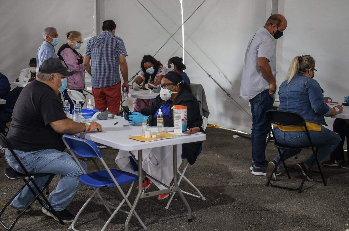 People register for the COVID-19 vaccination on Monday at the MDC North vaccine site run by FEMA. On Monday, March 22, people 50 and older became eligible for the vaccine statewide.