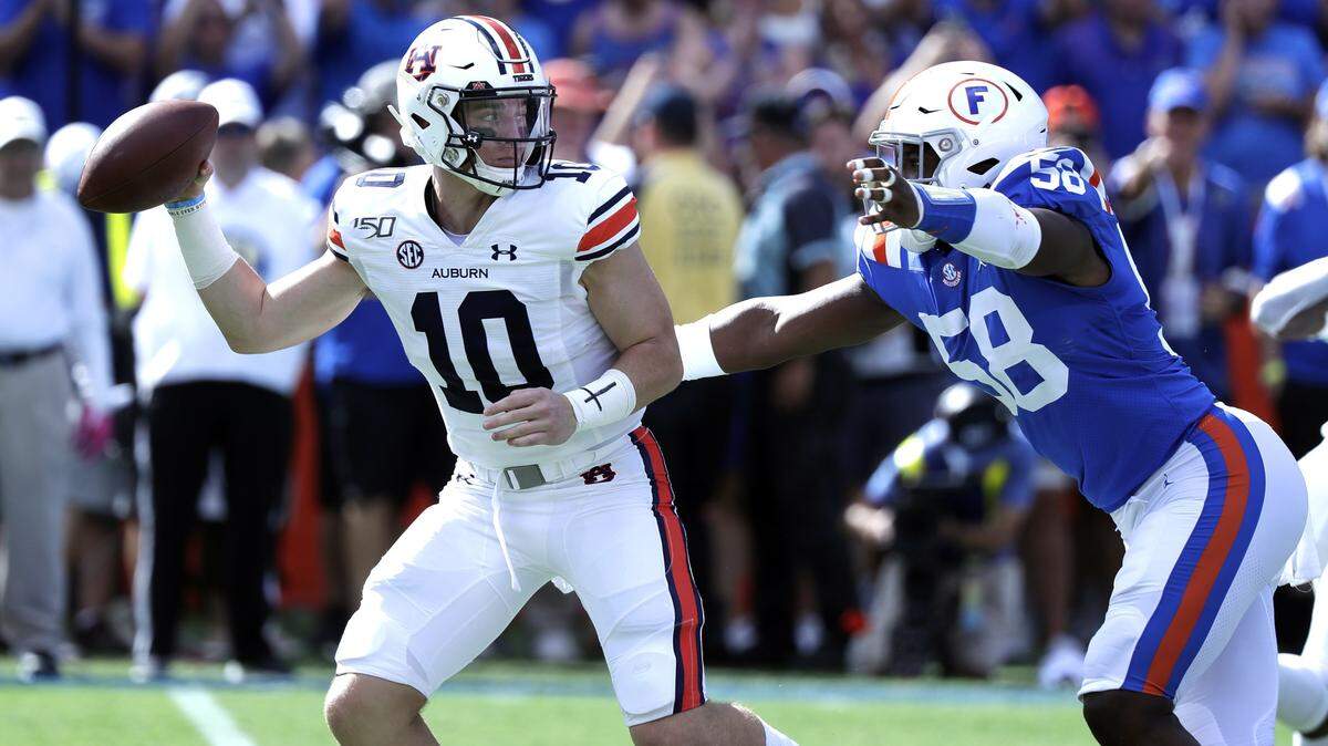 Auburn quarterback Bo Nix, left, is hit by Florida linebacker Jonathan Greenard (58) as he releases the ball during the first half of an NCAA college football game, Saturday, Oct. 5, 2019, in Gainesville, Fla. (AP Photo/John Raoux)