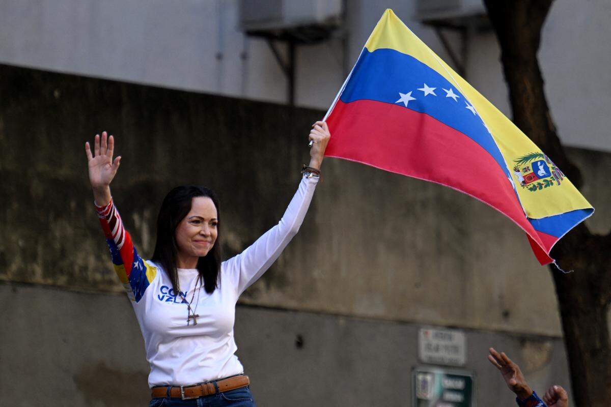Venezuelan opposition leader Maria Corina Machado waves a national flag during a protest called by the opposition on the eve of the presidential inauguration, in Caracas on January 9, 2025. Machado won the Nobel Peace Prize on Friday. (Photo by Juan BARRETO / AFP) (Photo by JUAN BARRETO/AFP via Getty Images)