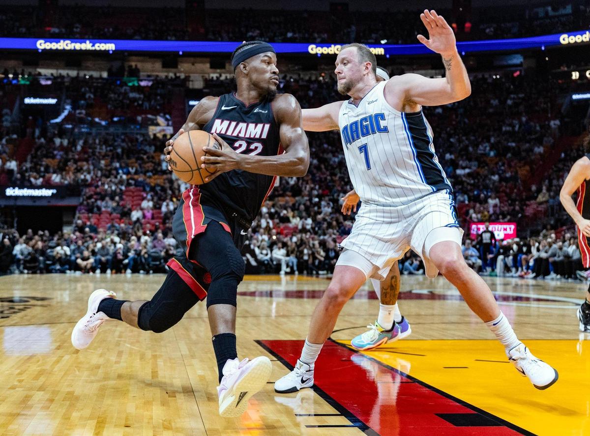 Miami Heat forward Jimmy Butler (22) goes up against Orlando Magic guard Joe Ingles (7) in the first half at the Kaseya Center in Miami, FL on Tuesday, February 6, 2024.