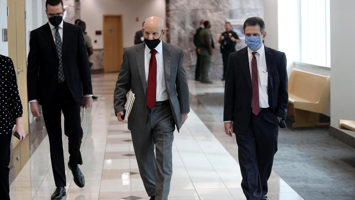 Broward senior prosecutor Mike Satz, center, is seeking the death penalty against Parkland school shooter Nikolas Cruz. Satz is pictured entering a courtroom in Fort Lauderdale on Friday, Oct. 15, 2021.