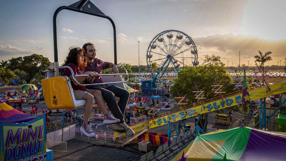 A young couple rides the ‘Sky Ride’ at the Miami-Dade County Fair