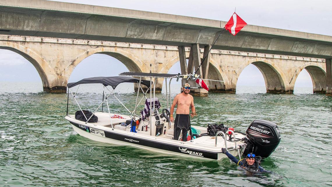 Keller Cabrera holds a Florida spiny lobster captured by diver Kevin Cabrera during the first day of lobster miniseason in the Florida Keys on Wednesday, July 26, 2023.