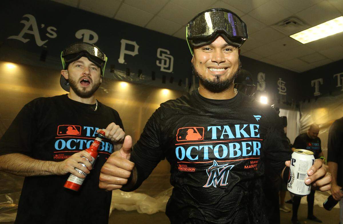 Sep 30, 2023; Pittsburgh, Pennsylvania, USA; Miami Marlins Garrett Hampson (left) and Luis Arraez (right) celebrate in the locker room after defeating the Pittsburgh Pirates at PNC Park to secure a berth in the 2023 MLB playoffs. Miami won 7-4. Mandatory Credit: Charles LeClaire-USA TODAY Sports