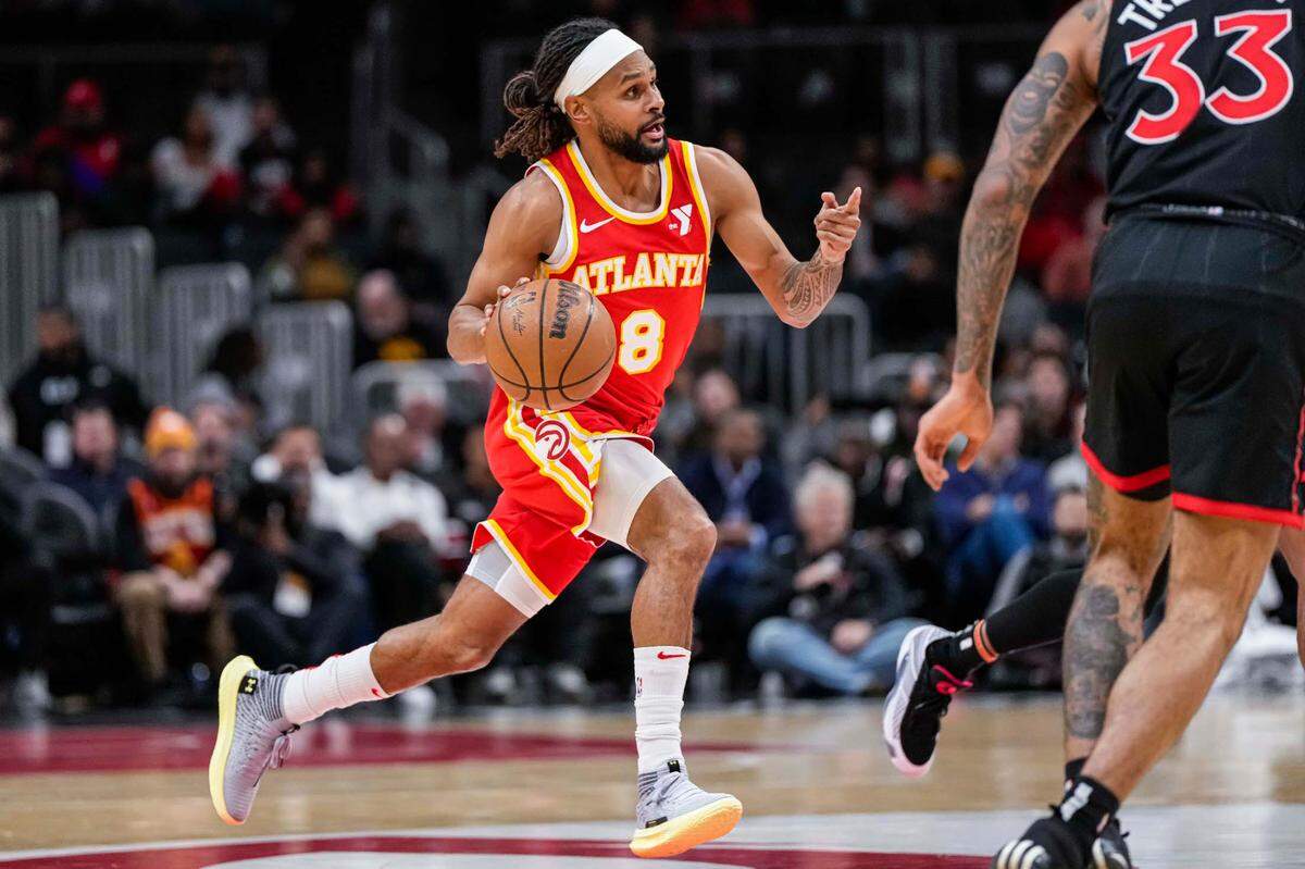 Then-Atlanta Hawks guard Patty Mills (8) brings the ball up the court against the Toronto Raptors during the first half at State Farm Arena.