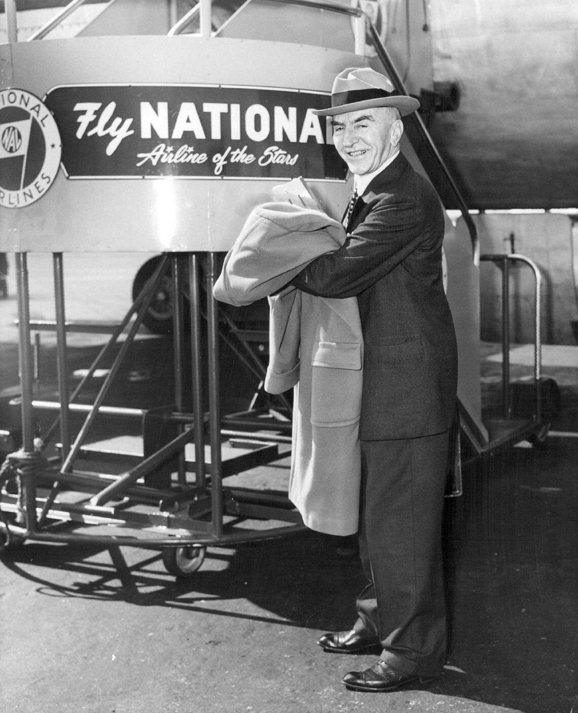 Eastern Airlines Chairman Eddie Rickenbacker gets ready to board a National Airlines flight for New Orleans at Miami International Airport in 1955. The National departure time suited Rickenbacker’s schedule better.