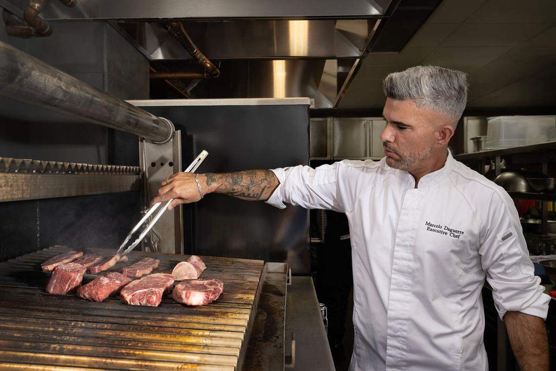 Chef Marcel Daguerre checks the meat on the grill at 1986 Steakhouse.