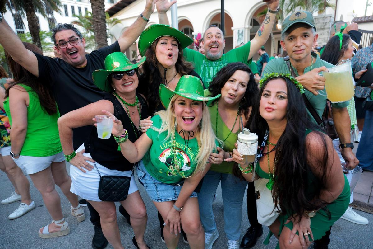 A group of people wearing St. Patrick’s Day costumes get their picture taken during the John Martin’s 32nd Annual St. Patrick’s Day Street Festival in Coral Gables, Florida, Saturday, March 15, 2025.