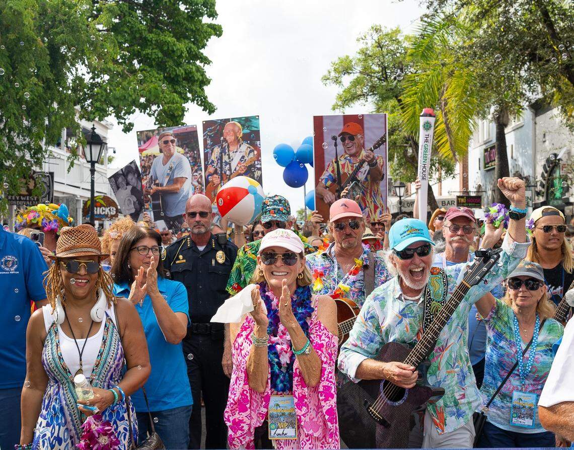 As fans blew bubbles and bounced beach balls, the Second Line Memorial Walking Parade honoring the late Jimmy Buffett proceeded along Duval Street in Key West, Fla., on Sunday, Aug. 31, 2025. Highlighting the island’s Just a Few Friends celebration, the march was led by a group including (front left) vocalist Nadirah Shakoor of Buffett’s Coral Reefer Band; (center front) his sister Lucy Buffett, renowned restaurateur and cookbook author; and (front right) Keys “trop-rock” musician Howard Livingston.