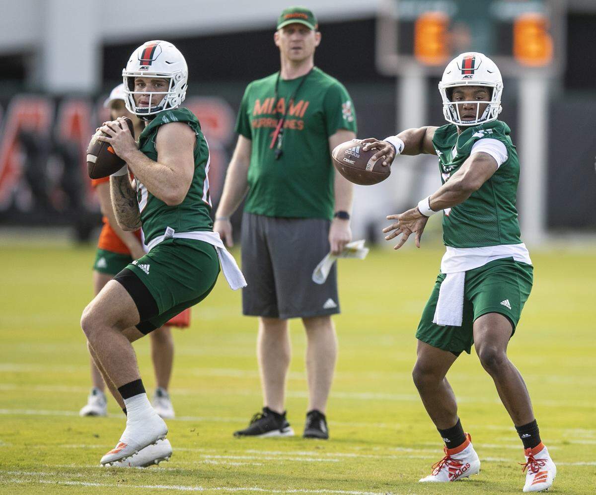 Miami Hurricanes offensive coordinator and quarterbacks coach Rhett Lashlee watches quarterbacks Tate Martell (18) and D’Eriq King (1) during practice at the University of Miami’s Greentree Field in Coral Gables on Monday, March 2, 2020.