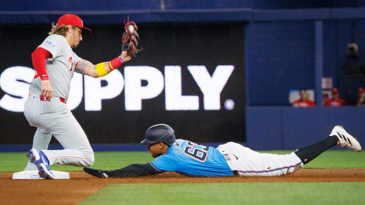 Miami Marlins shortstop Xavier Edwards (63) steals second base and Philadelphia Phillies second baseman Bryson Stott (5) fails to get him out during the first inning of a baseball game on Sunday, Sept. 8, 2024, at loanDepot Park in Miami.