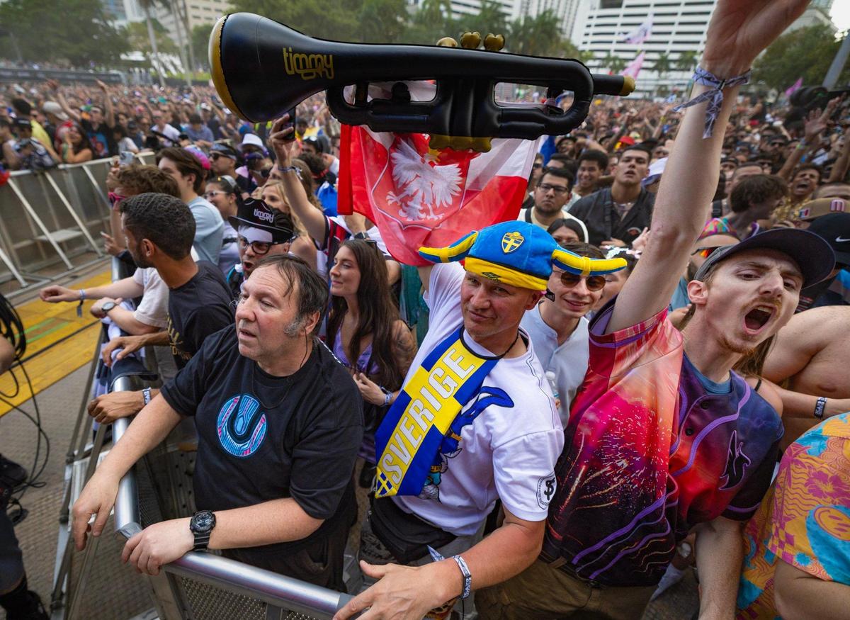 Michael Sonrot, at center, raises a inflatable trumpet during the performance by Timmy Trumpet at Ultra Music Festival’s 25th anniversary at Bayfront Park, in Miami, Florida, on Friday, March 28, 2025.