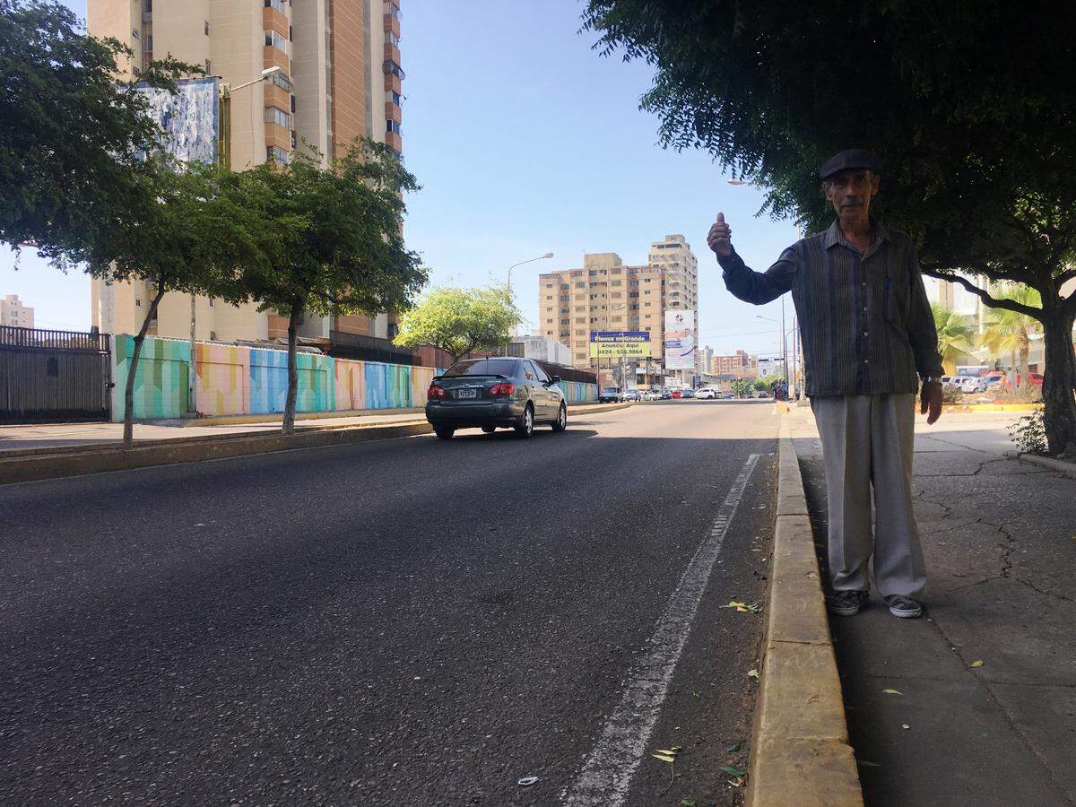 Heberto Caña, 80, says he hitchhikes because his monthly pension is not enough to pay for transportation.