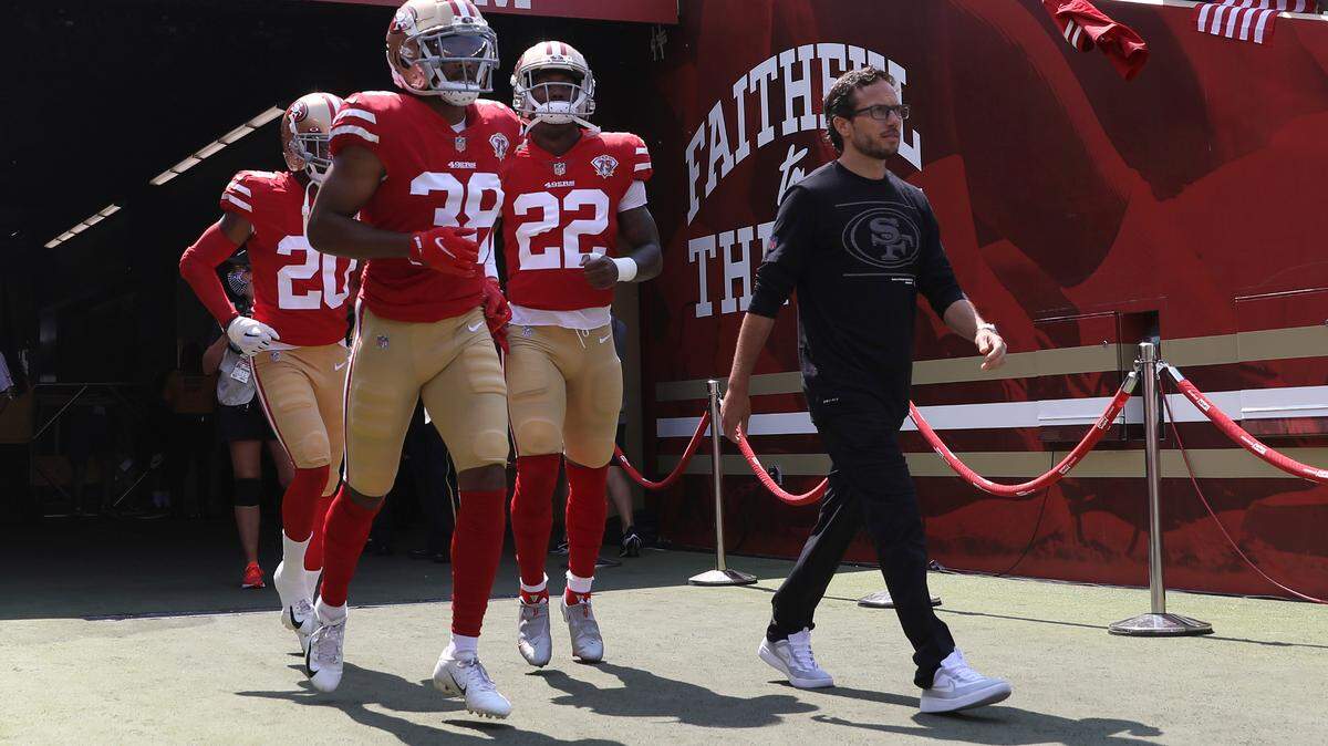 San Francisco 49ers offensive coordinator Mike McDaniel, right, walks onto the field with Ambry Thomas (20), cornerback Deommodore Lenoir (38) and running back Wayne Gallman II (22) before an NFL preseason football game against the Las Vegas Raiders in Santa Clara, Calif., Sunday, Aug. 29, 2021. (AP Photo/Jed Jacobsohn)