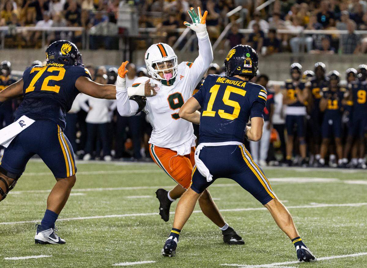 Miami Hurricanes defensive lineman Tyler Baron (9) runs toward California Golden Bears quarterback Fernando Mendoza (15) as he looks to throw the ball in the second half of their NCAA college football game at the California Memorial Stadium on Saturday, Oct. 5, 2024, in Berkeley, Calif.