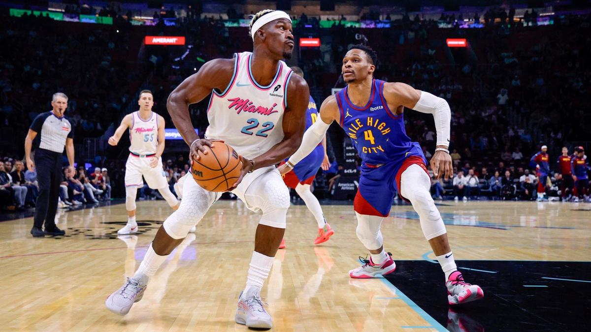 Miami Heat forward Jimmy Butler (22) keeps an eye on the basket as Denver Nuggets guard Russell Westbrook (4) defends in the first half during their NBA basketball game at the Kaseya Center in Miami, Florida on Friday, January 17, 2025.