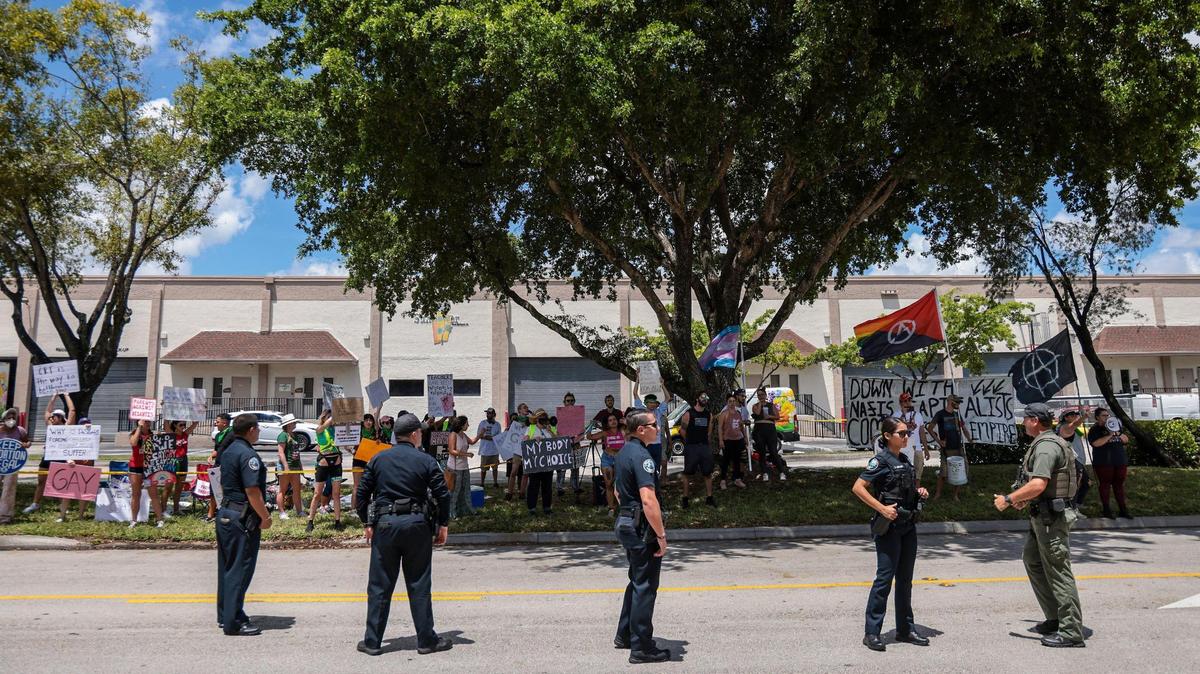 Doral police standby as a group of about 40 people protests at a campaign event for Gov. Ron DeSantis’ education agenda Sunday, August 21, 2022, outside the Metro-Dade Firefighters Local 1403 in Doral, Florida.