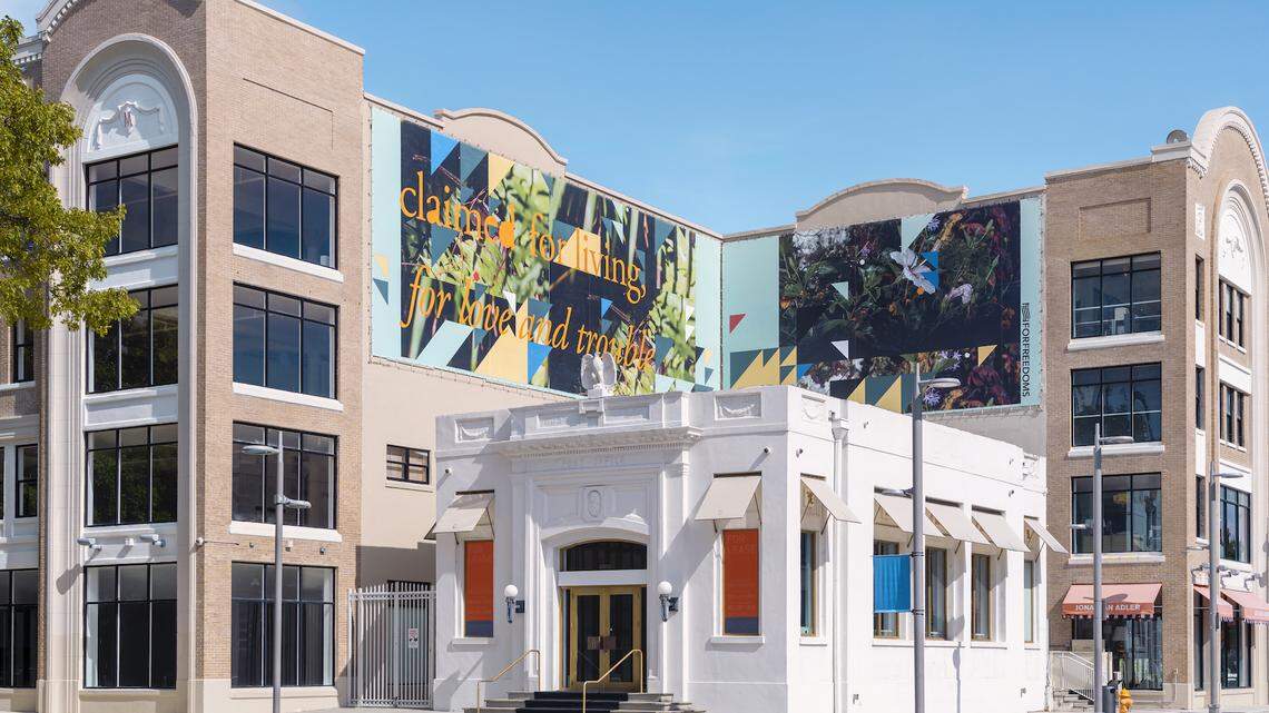 Miami artist Adler Guerrier’s billboard, “claimed for living, for love and trouble,” along the Moore Building in the Design District.