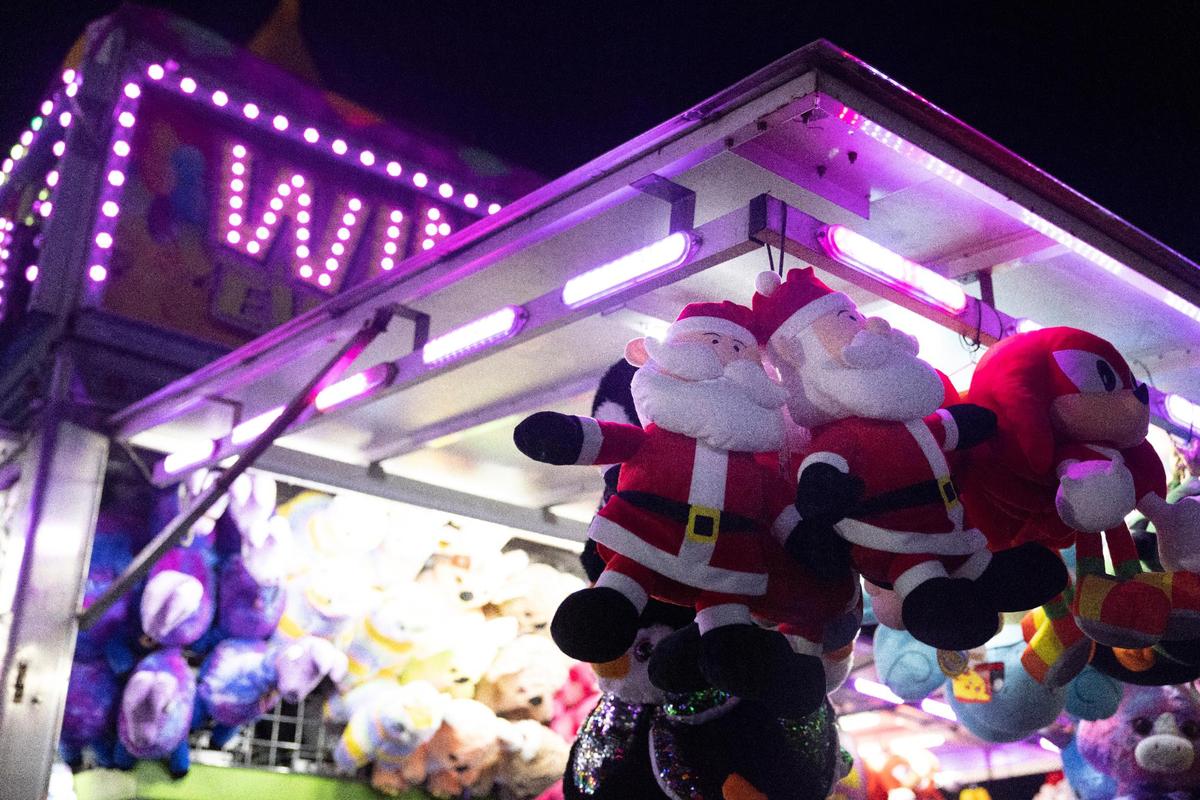 Stuffed Santa’s hang from a carnival game during the opening night of Santa’s Enchanted Forest.