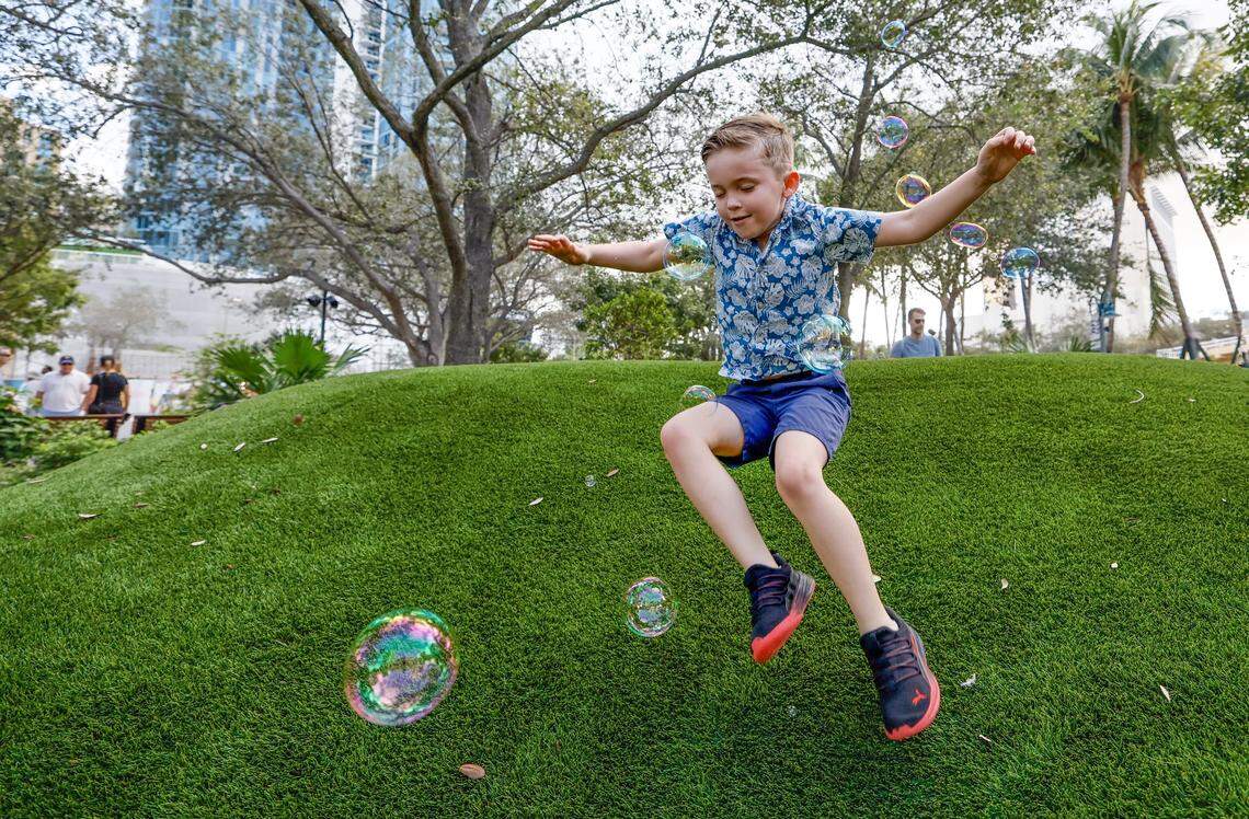 Colton Saye, 6, chases bubbles while running down a mound at Huizenga Park that reopened on Saturday, January 24, 2026, after a major renovation with a ribbon cutting ceremony in Fort Lauderdale, Florida.