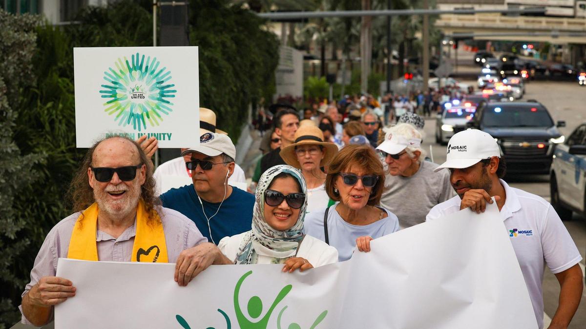 From left to right: Reverend Tom Capo, Tehsin Siddiqui, Nadine Asin, and Matt Anderson lead the We Are United march over the bridge into Brickell on Sunday, Nov. 5, 2023.