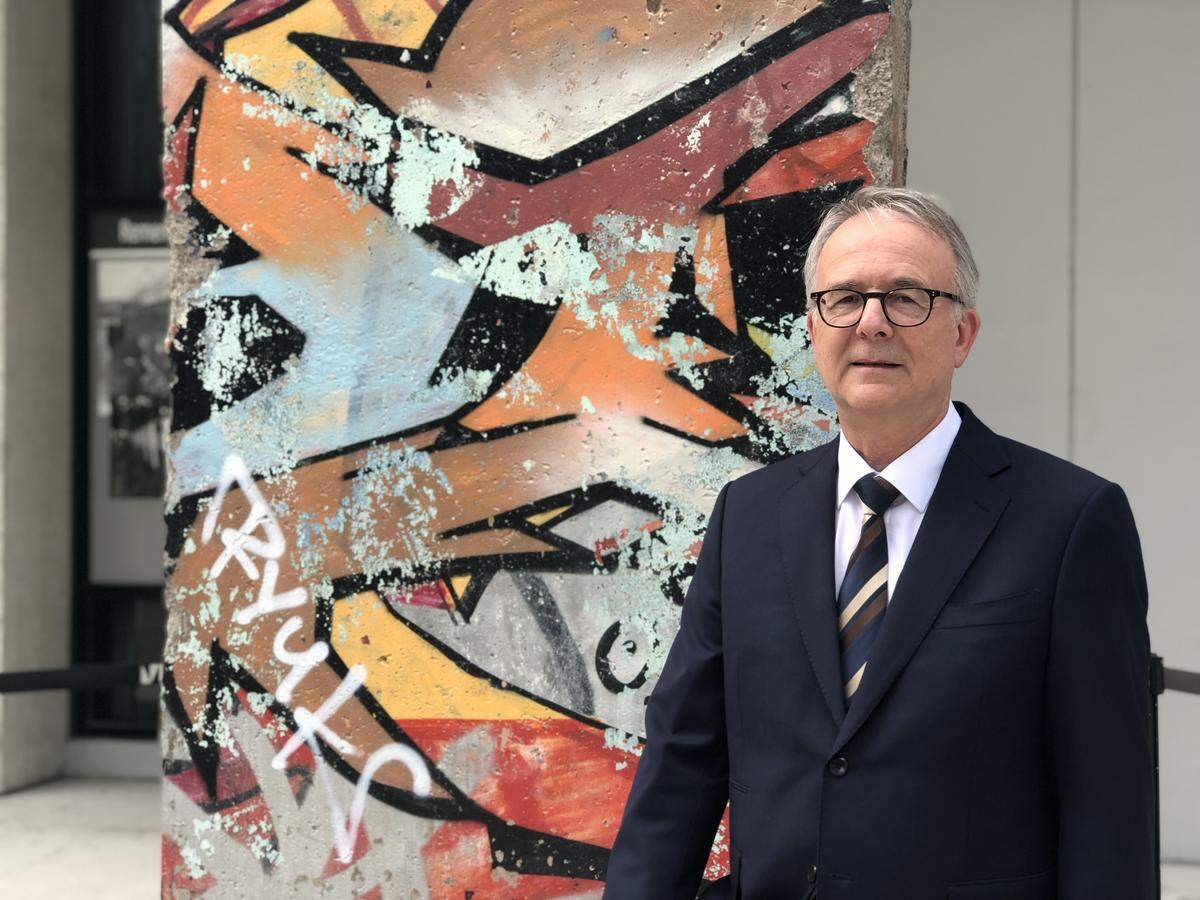 Andreas Siegel, Consul General of Germany in Miami, in front of a piece of the Berlin Wall that is preserved at the Wolfson Campus of Miami Dade College. This November 9 marks the 30th anniversary of the fall of the Berlin Wall.
