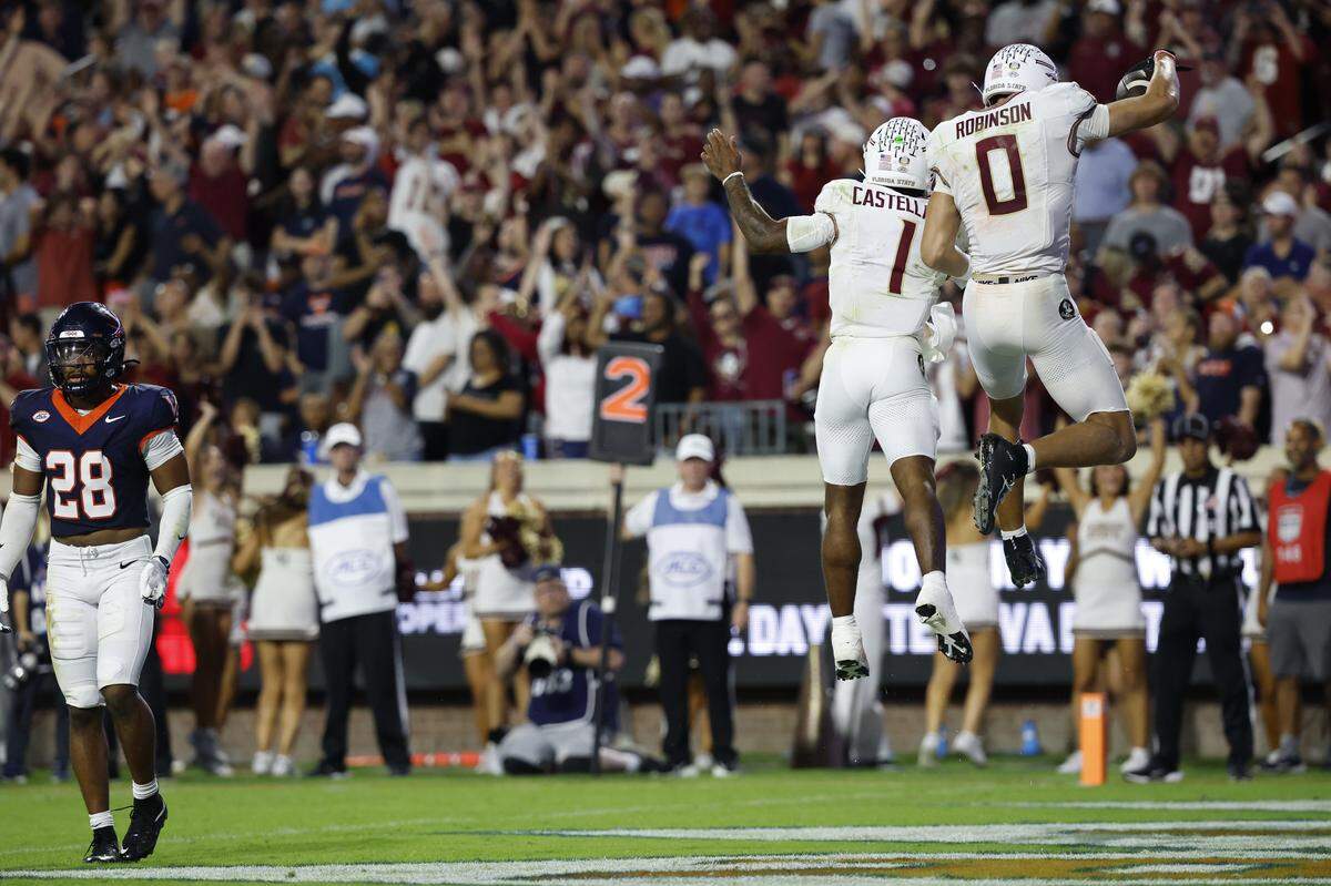 Sep 26, 2025; Charlottesville, Virginia, USA; Florida State Seminoles wide receiver Duce Robinson (0) celebrates with Seminoles quarterback Tommy Castellanos (1) after catching a touchdown pass against the Virginia Cavaliers at Scott Stadium.