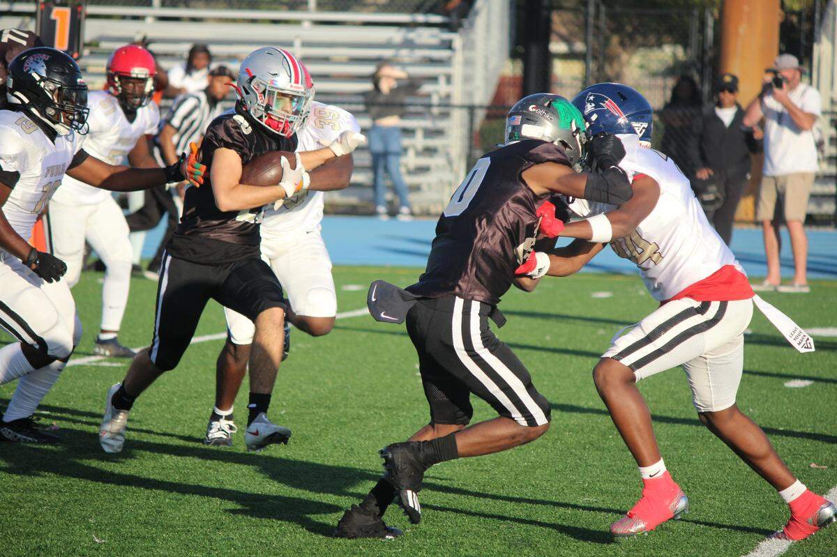 Doral Academy running back Jorge Delanuez churns for yards for the Private School All-Stars on Saturday in the 13th annual Private vs. Public All-Star Game at Betty Ferguson Park in Miami Gardens.