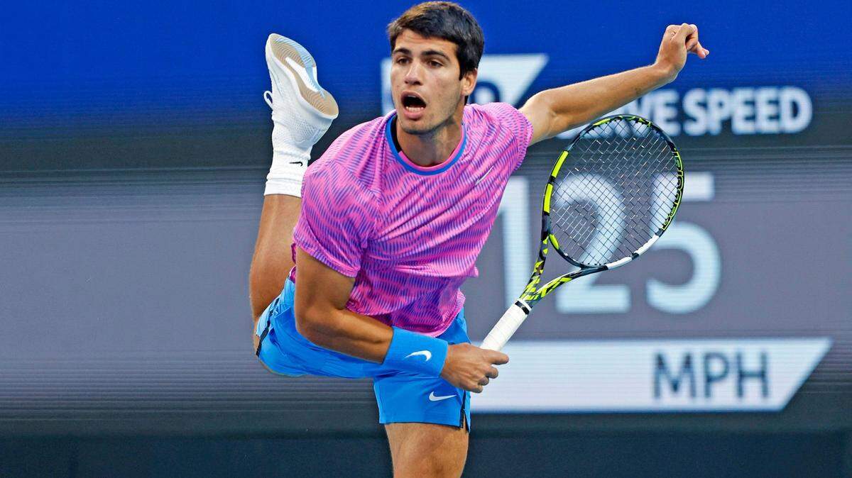 Carlos Alcaraz of Spain serves to Grigor Dimitrov of Bulgaria during the Miami Open Tennis Tournament at Hard Rock Stadium in Miami Gardens, Florida on Thursday, March 28, 2024.

