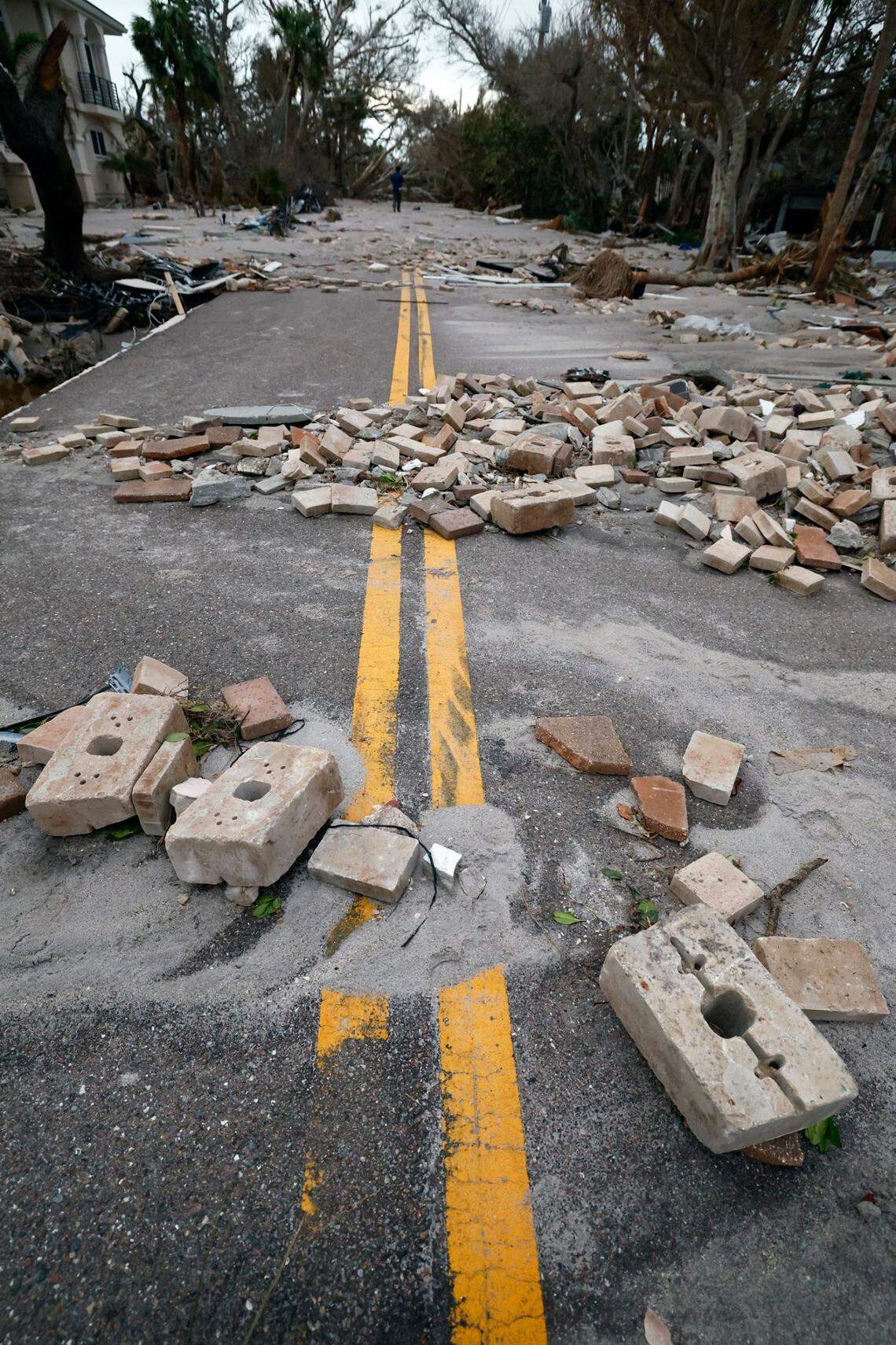 Beach sand and bricks washed up on Manasota Key Road