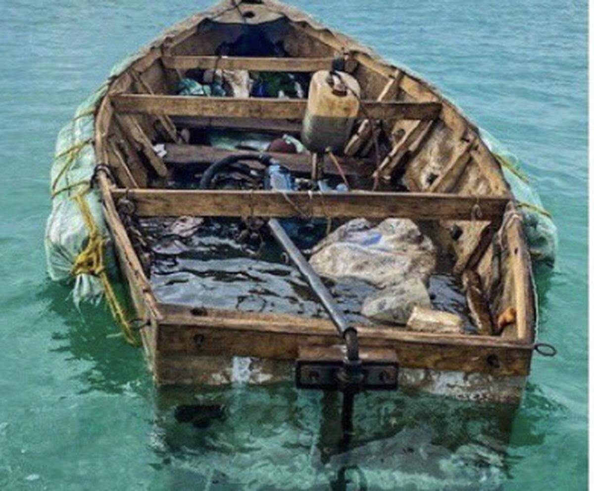 A boat that ferried seven Cubans to the Florida Keys floats in Boot Key Harbor in the city of Marathon Tuesday, Jan. 12, 2021.