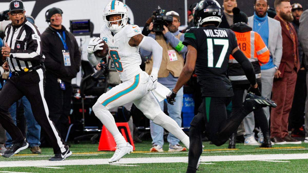 Miami Dolphins safety Jevon Holland (8) runs after intercepting a pass during second quarter of an NFL football game against the New York Jets at MetLife Stadium on Friday, Nov. 24, 2023 in East Rutherford, New Jersey.