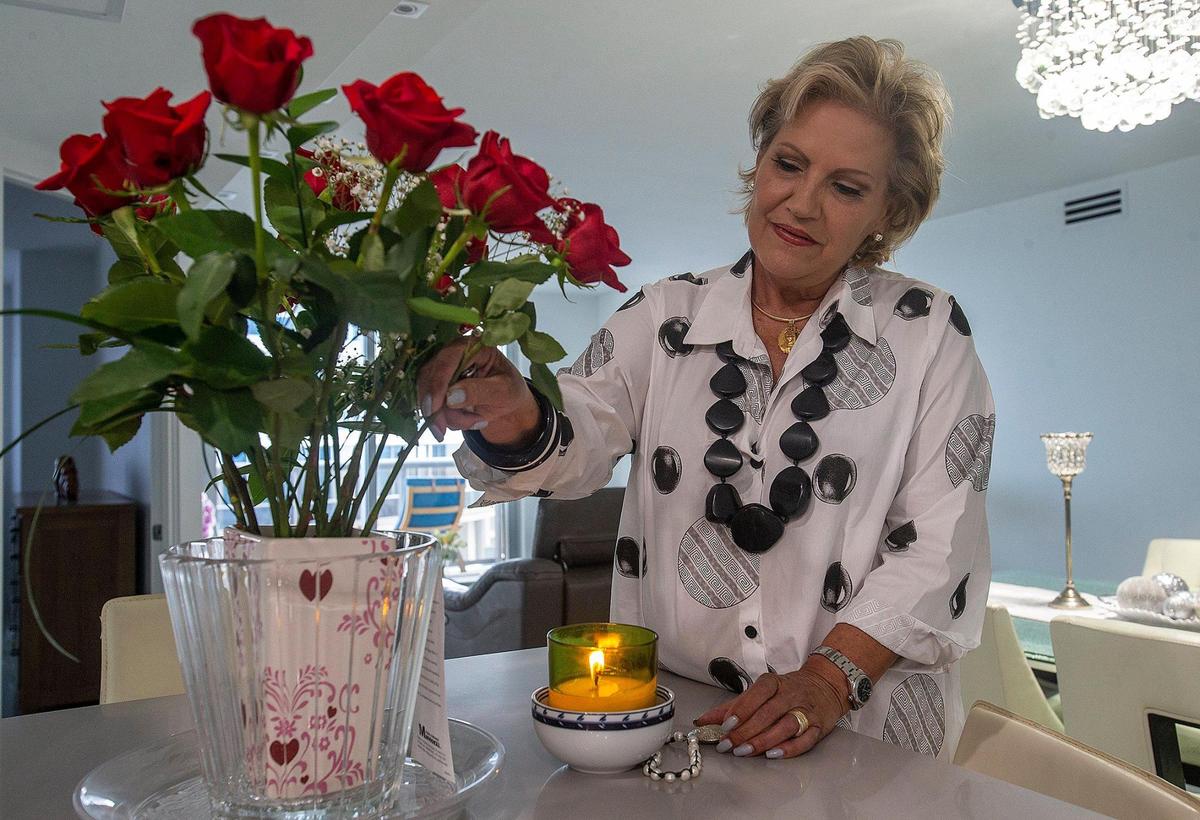 Iliana Monteagudo, lit a candle to the “La Virgen de Guadalupe“ image she keeps in the apartment she is renting in Miami Beach on Sept. 9, 2021. She is one of the very few survivors from the collapsed portion of Champlain Towers South. She escaped from unit 611 by running down six flights of stairs.