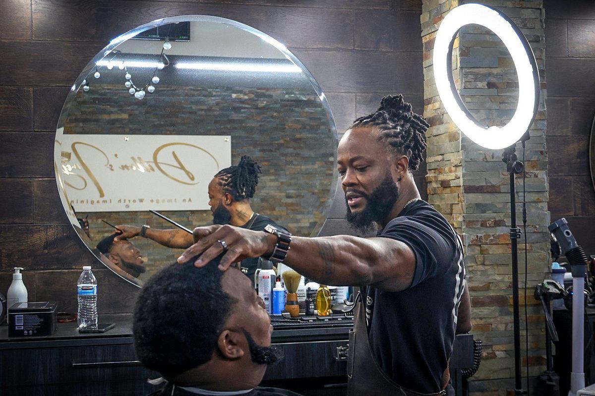 Coral Springs resident and owner of the Lauderhill barbershop, Dillon’s Image, Dwayne Dillon, 41, chats with his client, Bryan Gibson, 30, left, of Miami. The Miami Herald listened in as Dillon and his clients discussed the upcoming presidential elections.