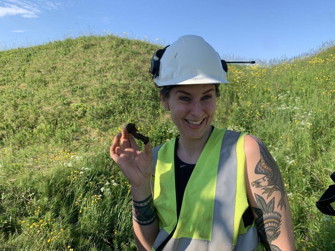 Archaeologist Hanne Brynn holds the ship rivet.