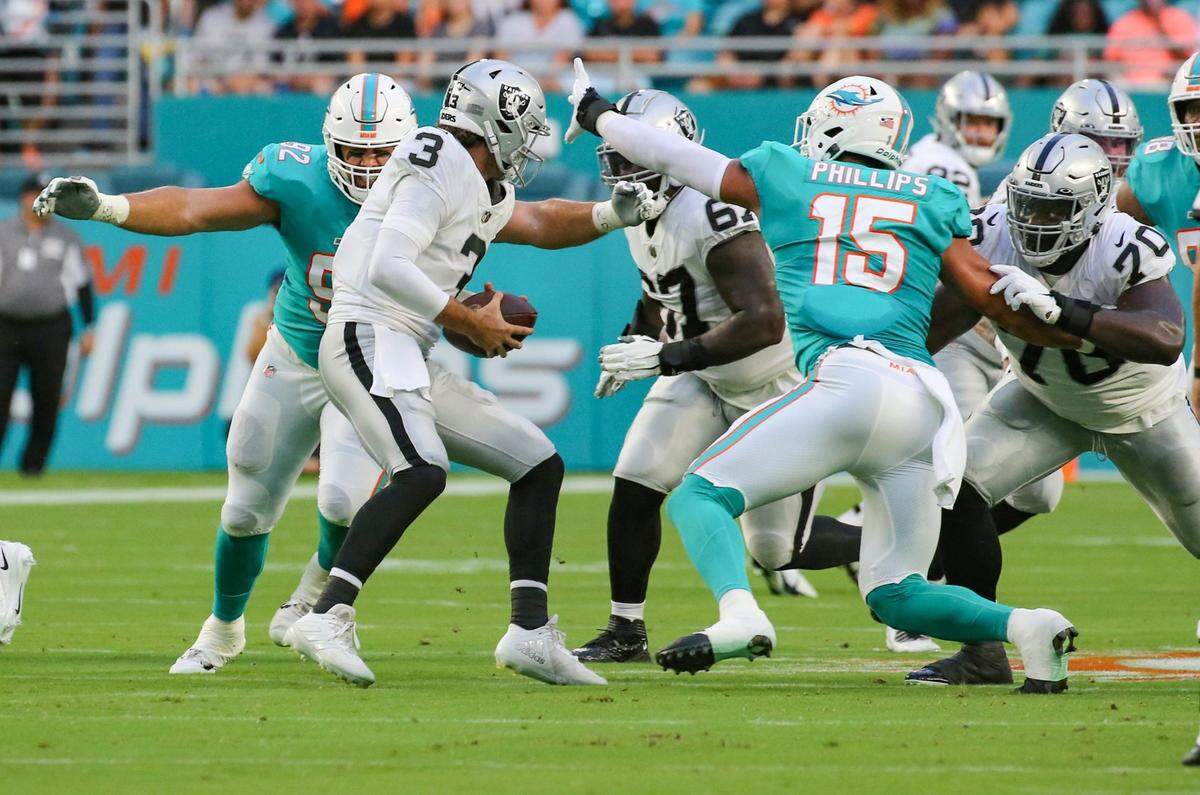 Miami Dolphins defensive tackle Zach Sieler (92) and linebacker Jaelan Phillips (15) sack Las Vegas Raiders quarterback Jarrett Stidham (3) in the first quarter at Hard Rock Stadium in Miami Gardens on Saturday, August 20, 2022.
