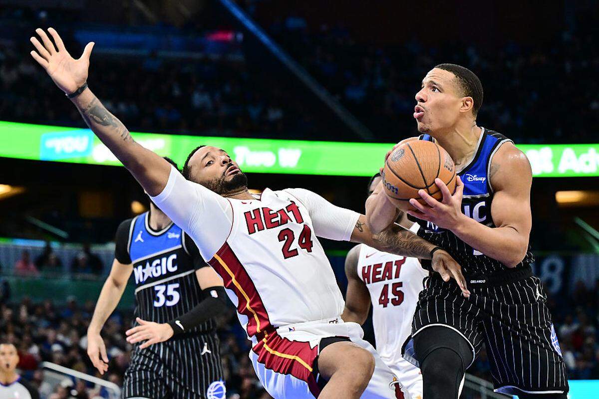 Desmond Bane #3 of the Orlando Magic draws a foul from Norman Powell #24 of the Miami Heat in the second half of a Emirates NBA Cup Quarterfinals game at Kia Center on December 09, 2025 in Orlando.