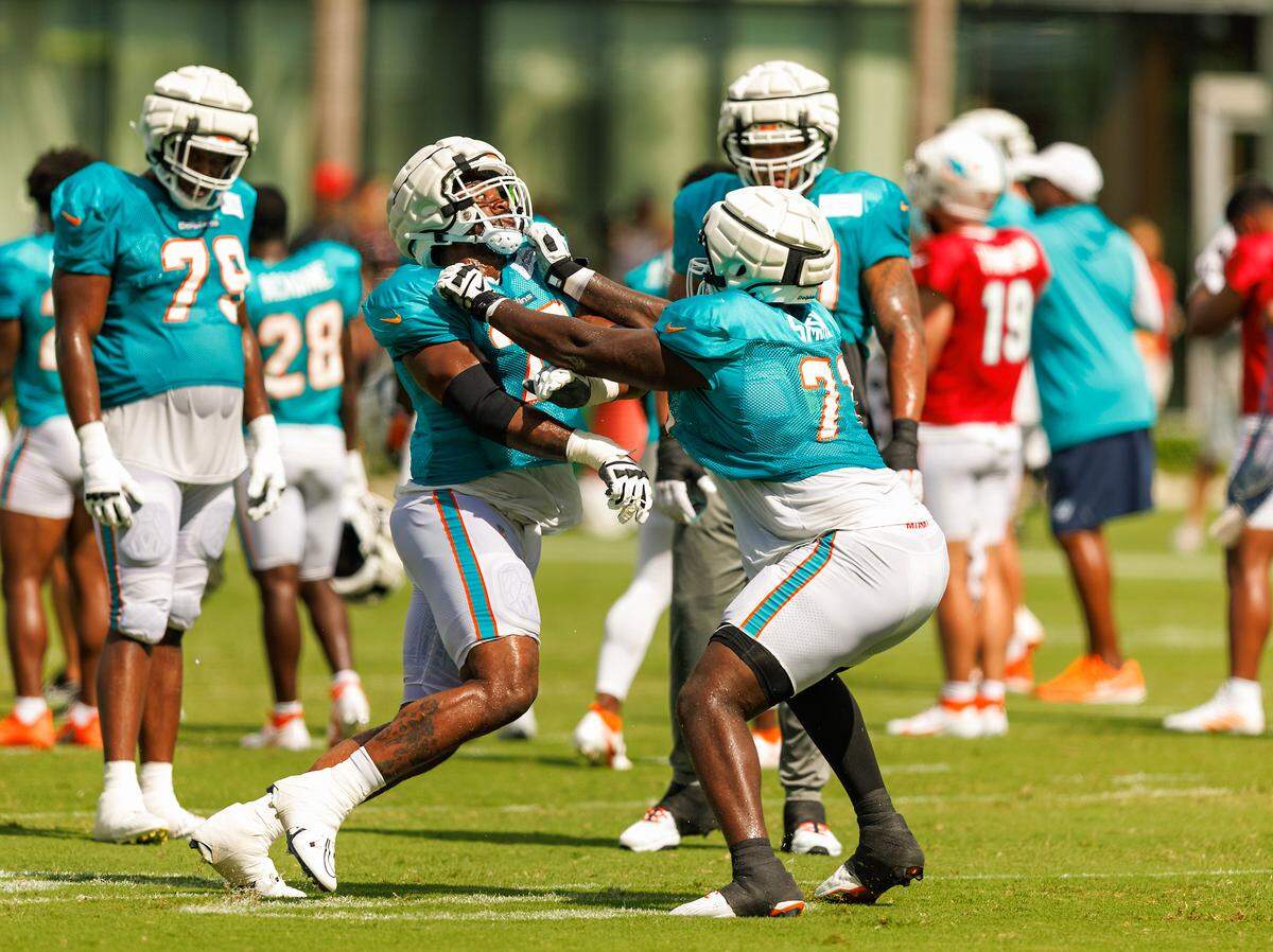 Miami Dolphins guard Austin Jackson (73) and Miami Dolphins offensive tackle Kion Smith (71) participate in a drill during a joint practice with the Atlanta Falcons at Baptist Health Training Complex in Hard Rock Stadium on Wednesday, August 9, 2023 in Miami Gardens, Florida.