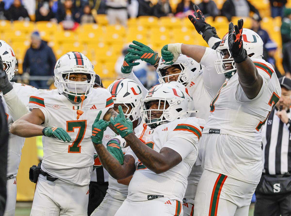 Miami Hurricanes wide receiver CJ Daniels (7) celebrates his touchdown pass reception with teammates during the second half of their NCAA football game against the Pittsburgh Panthers at Acrisure Stadium in Pittsburgh, PA, on Saturday, November 29, 2025.