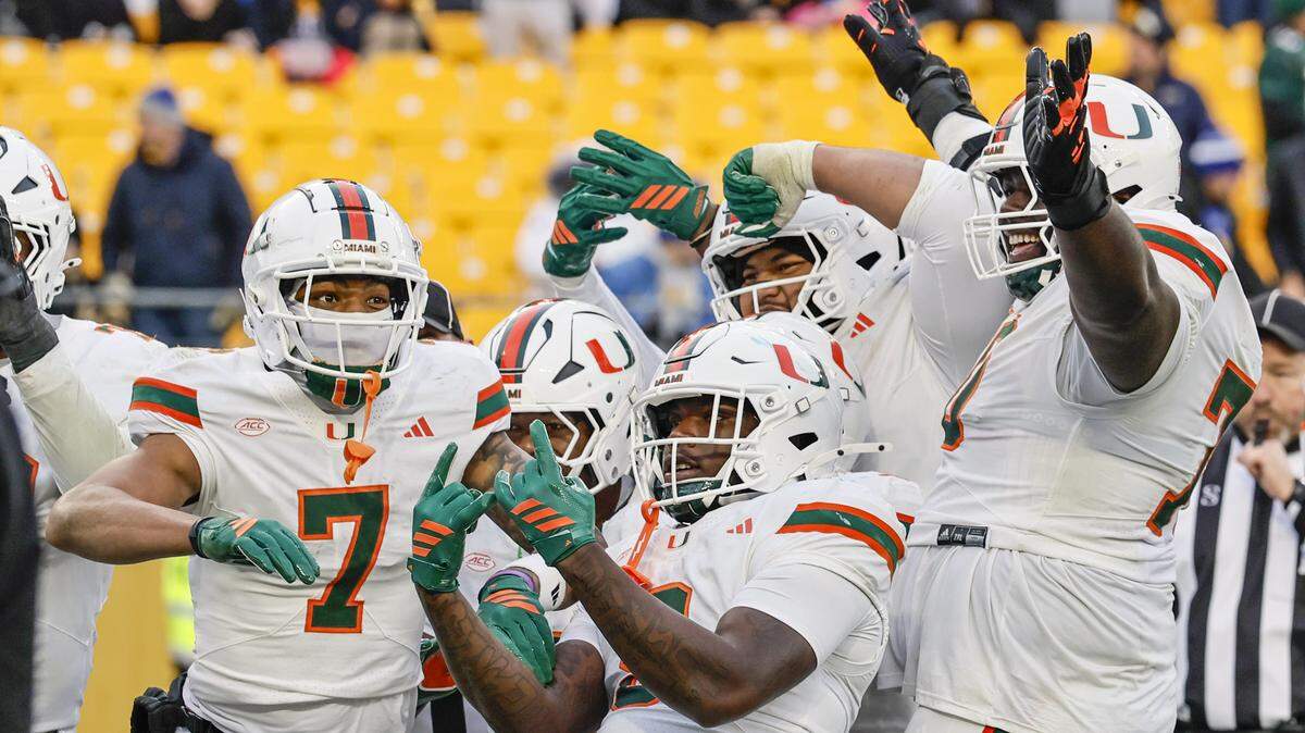 Miami Hurricanes wide receiver CJ Daniels (7) celebrates his touchdown pass reception with teammates during the second half of their NCAA football game against the Pittsburgh Panthers at Acrisure Stadium in Pittsburgh, PA, on Saturday, November 29, 2025.