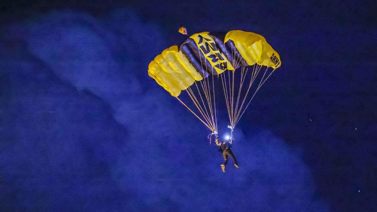 A U.S. Army parachutist approches a beach night landing during Memorial Day Weekend at the Hyundai Air & Sea Show in Miami Beach, Florida, on Saturday, May 23, 2026.