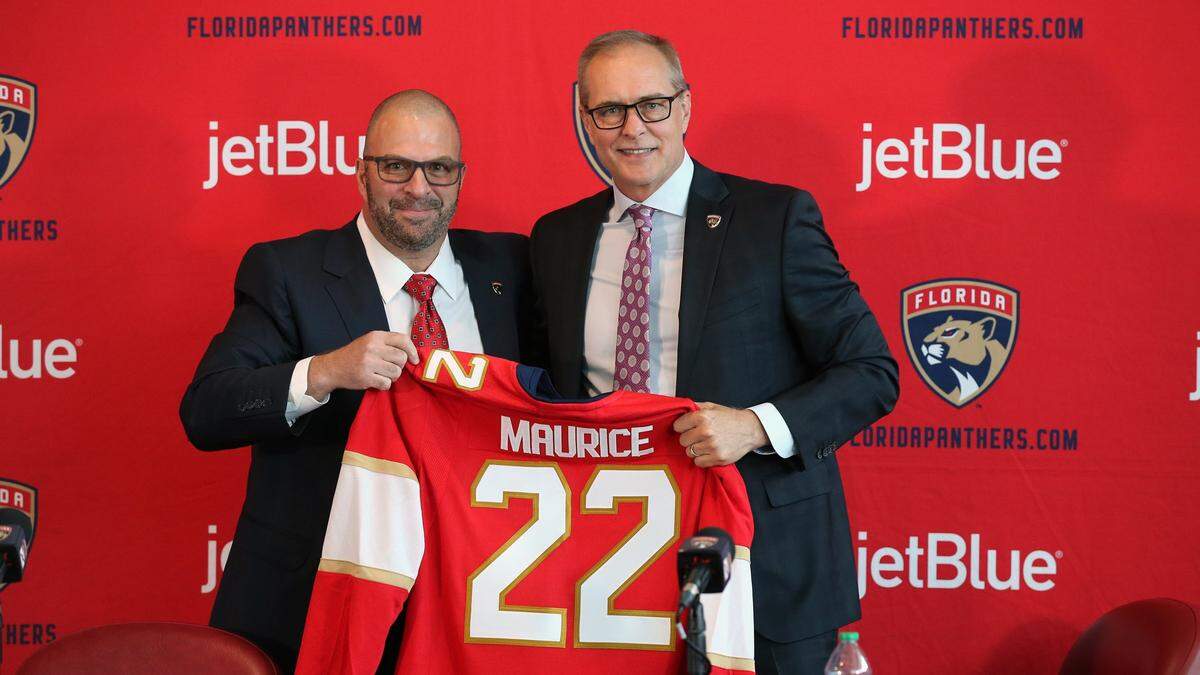 Florida Panthers general manager Bill Zito, at left, introduces new coach Paul Maurice and his team jersey during a press conference at the FLA Live Arena in Sunrise Florida on Thursday, June 23, 2022.