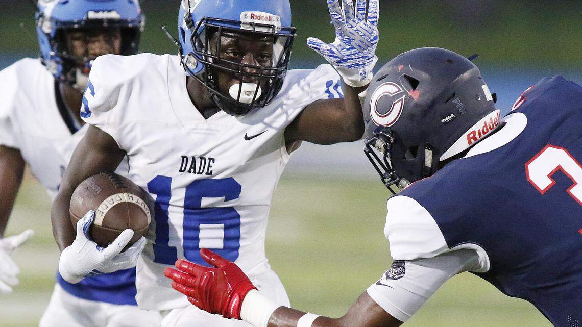 South Dade Buccaneers’ running back Willie Thomas (16) tries to escape Columbus Explorers’ defender during the football game on Fri., Sept. 6, 2019 at Tropical Park Stadium in Miami