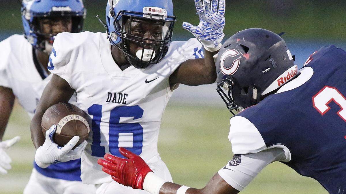South Dade Buccaneers’ running back Willie Thomas (16) tries to escape Columbus Explorers’ defender during the football game on Fri., Sept. 6, 2019 at Tropical Park Stadium in Miami
