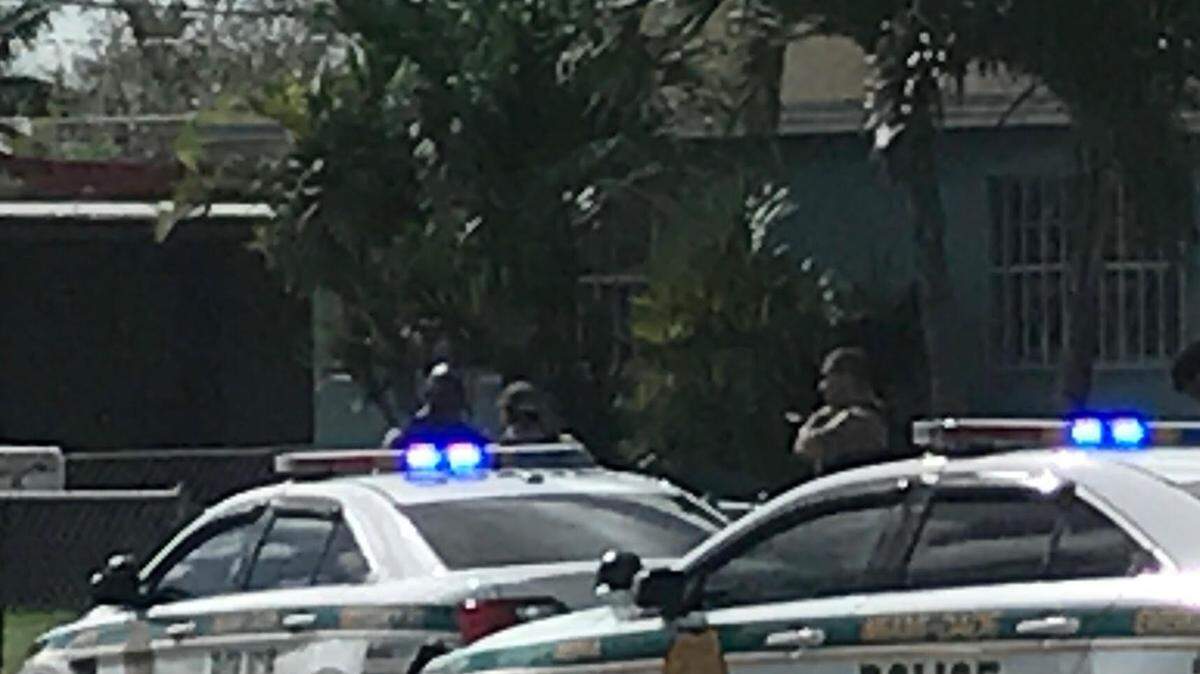 Miami-Dade police question residents Wednesday, Nov. 14, near a home in Goulds in south Miami-Dade County where a man and woman were shot the night before. The man, Clifton Mann, 23, died from his wounds at Jackson Memorial Hospital South.