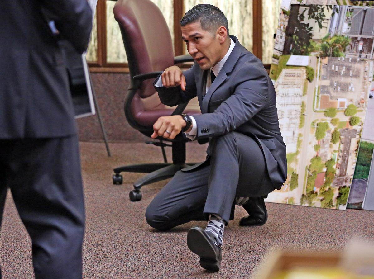 North Miami Police Officer Jonathan Aledda takes a firing position as he testifies in his own defense on Wednesday, March 13, 2019. He’s accused of attempted manslaughter for shooting at an autistic man, and wounding the man’s unarmed caretaker.