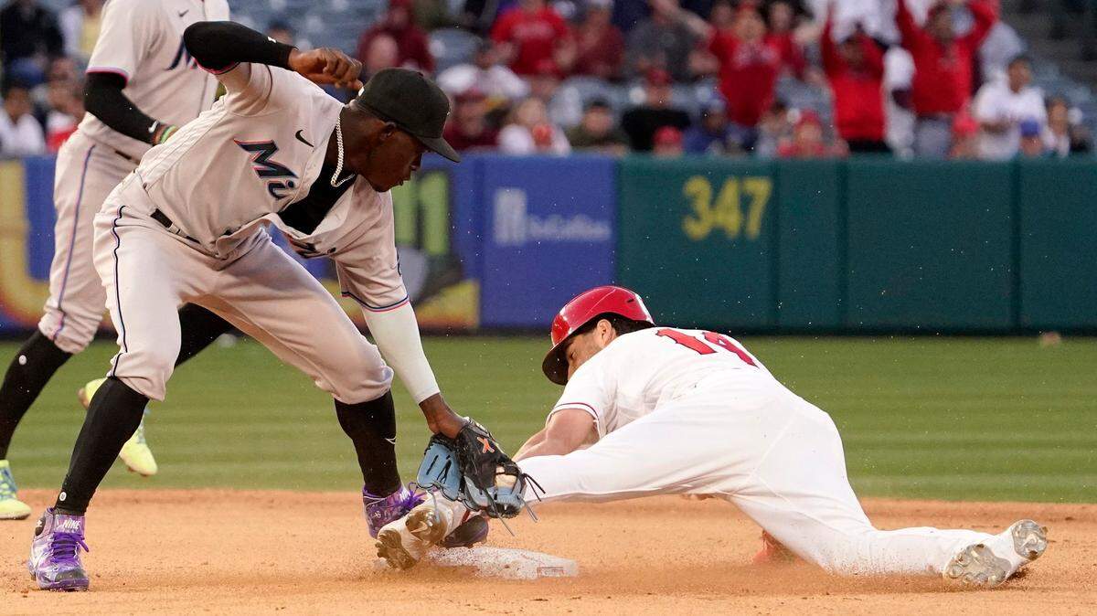 Los Angeles Angels’ Tyler Wade, right, steals second under the tag of Miami Marlins second baseman Jazz Chisholm Jr. during the ninth inning of a baseball game Tuesday, April 12, 2022, in Anaheim, Calif. Wade was called safe on the play after a replay. (AP Photo/Mark J. Terrill)