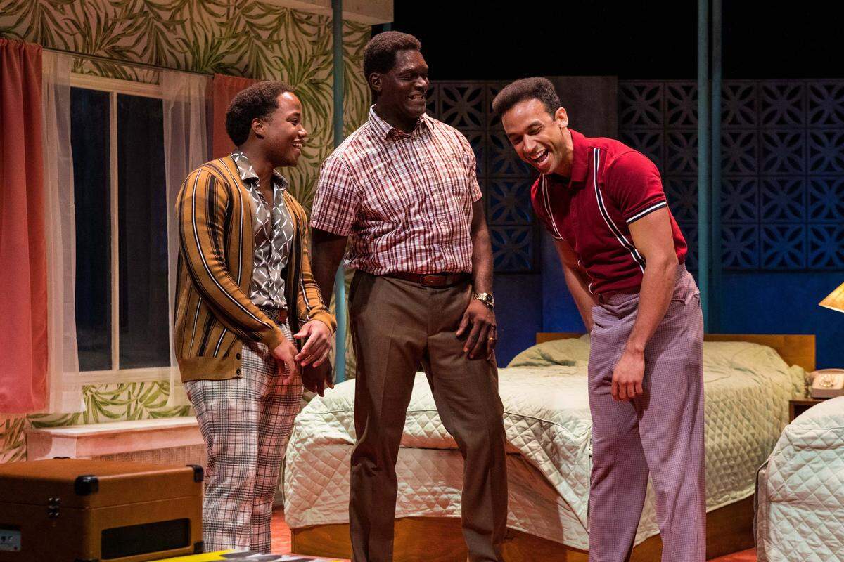 Leon Thomas III’s Sam Cooke, Esau Pritchett’s Jim Brown and Kieron Anthony’s Cassius Clay party after Clay captures the World Heavyweight crown in Miami New Drama’s “One Night in Miami.”