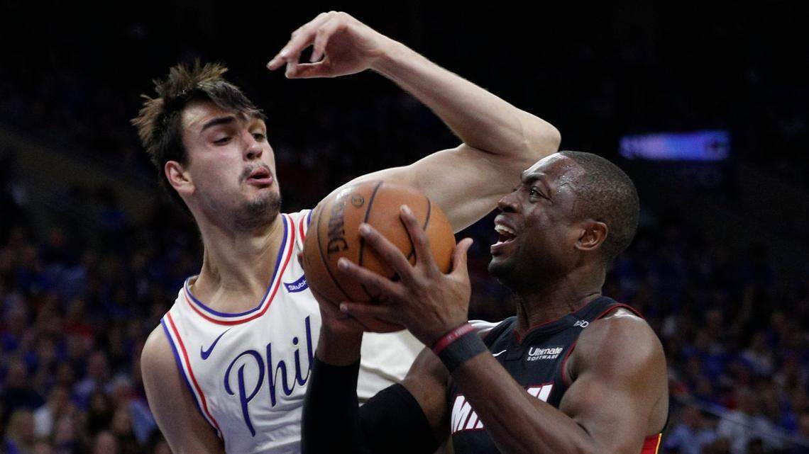 Miami Heat's Dwyane Wade, right, makes his move against Philadelphia 76ers' Dario Saric, left, of Croatia, during the first half in Game 1 of a first-round NBA basketball playoff series, Sat., April 14, 2018, in Philadelphia.